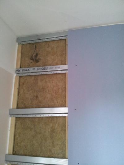 Stud partition built, insulation fitted & resilient bars installed. 2 Layers of Soundbloc Plasterboard Installed