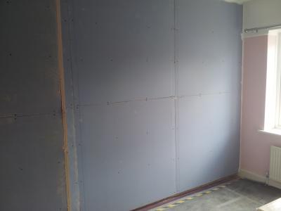 Stud partition built, insulation fitted & resilient bars installed. 2 Layers of Soundbloc Plasterboard Installed